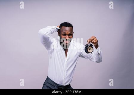Lächelnder junger afroamerikanischer Mann 20s mit legerem Hemd Brille Mütze Stehfoto Stockfoto