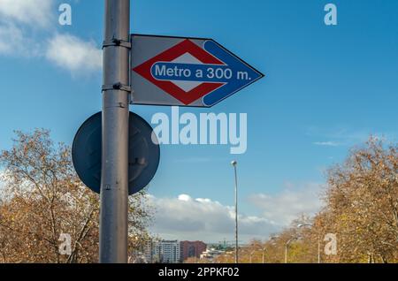 MADRID, SPANIEN - 27. DEZEMBER 2021: Schild mit der Entfernung und Richtung zur nächsten U-Bahnstation in Madrid, Spanien Stockfoto