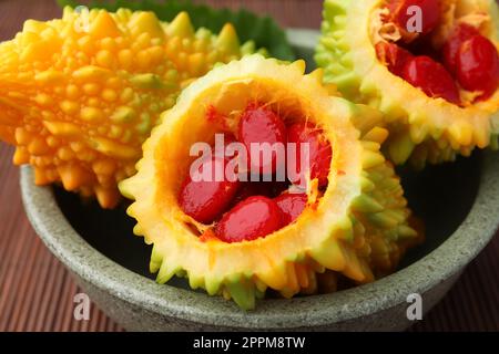 Viele frische bittere Melonen in der Schüssel auf dem Tisch, Nahaufnahme Stockfoto