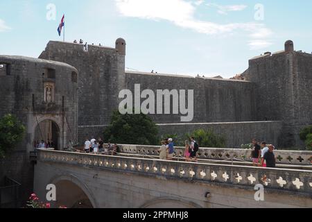 Pile Gate Dubrovnik Kroatien August 14 2022 Menschen Männer und Frauen gehen entlang der Steinbrücke zum Tor der Altstadt. Eine Menge Touristen. Geschäftiger Eingang. Haupteingang Altstadt, geschäftiges Pile Gate Stockfoto