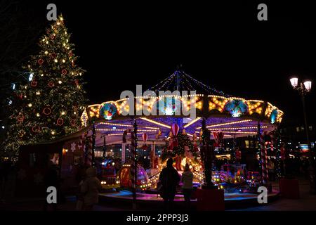 Straßburg, Frankreich - 13. Dezember 2022: Karussell und weihnachtsbaum auf dem Weihnachtsmarkt in Straßburg, Place Kleber. Stockfoto