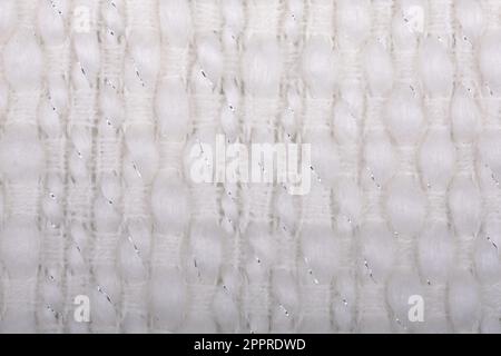 Artic White, zartes, weiches, gewebtes Gewebe aus Acrylwolle für nahtlosen Hintergrund. Bequemes Stylingtuch, selektiver Soft Focus für Wärme Stockfoto