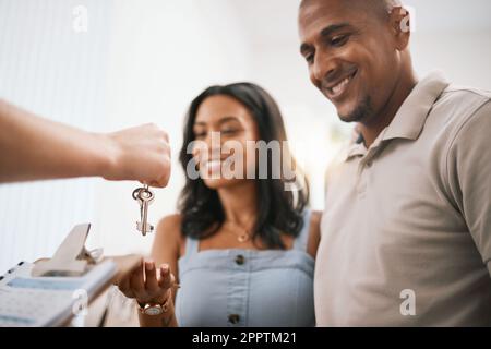 Glückliches Paar, Immobilienbesitzer und Hausbesitzer mit Schlüsseln vom makler für den Kauf von Immobilien, Hypothekendarlehen oder Investitionen. Mann und Frau mit Lächeln als Schlüssel Stockfoto