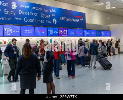 Passagiere, die die automatische Gepäckabgabefunktion von British Airways im South Terminal, Flughafen London Gatwick, England, Großbritannien nutzen Stockfoto