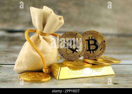 Physische Version von Bitcoin, neues virtuelles Geld. Konzeptionelles Bild für Investoren in Kryptowährung und Gold. Stockfoto