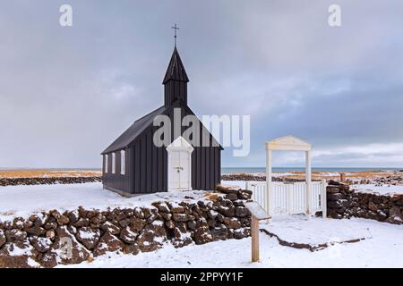 Die alte hölzerne Pfarrkirche Búðakirkja / Budakirkja in der Nähe von Búðir / Budir im Winter auf der Snæfellsnes-Halbinsel, westliche Region / Vesturland, Island Stockfoto