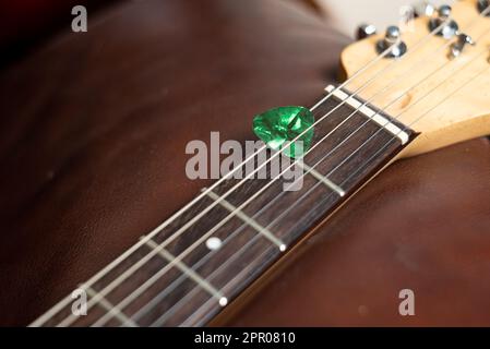 Gitarrenpick in Strings gehalten Stockfoto