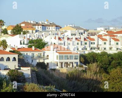 Blick auf weiße Häuser mit orangefarbenen Ziegeldächern in der portugiesischen Küstenstadt Sines Stockfoto