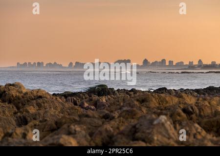 Die Skyline von Punta del Este während eines goldenen Sonnenuntergangs aus der Ferne zu sehen Stockfoto