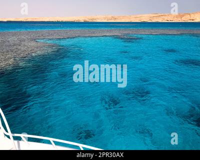 Eine weiße Yacht, ein Boot, ein Schiff ist in einer Jam, parkt, ankert im Meer, das Meer mit klarem blauem Salzwasser mit einem Grund von Korallenriffen am Bach Stockfoto