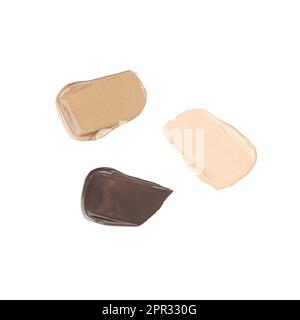 Verschiedene Hauttonabstriche von Make-up-Fundamenten auf Weiß. Stockfoto
