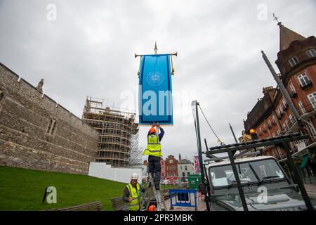 Windsor, Berkshire, Großbritannien. 26. April 2023. Riesige Union Jack und blaue feierliche Krönungsflaggen wurden heute außerhalb von Windsor Castle in ihre Position gebracht, während sich die Stadt für die Feiertage der Krönungsbank am Wochenende bereitstellt. Das Krönungskonzert für König Charles und Königin Camilla mit einer Reihe von Gästen, darunter Lionel Ritchie, findet am 7. Mai 2023 auf dem Privatgelände von Windsor Castle statt und die Stadt wird voraussichtlich sehr belebt sein. Kredit: Maureen McLean/Alamy Live News Stockfoto