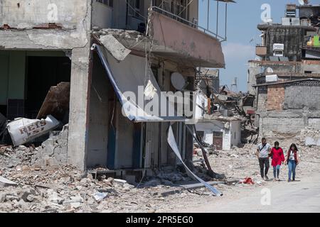 Antakya, Türkei. 26. April 2023. Die Bewohner gehen vorbei an Ruinen in den Trümmern der Altstadt von Antakya. Offiziellen Zahlen zufolge wurden beim Erdbeben im Februar 6 mehr als 50.000 Menschen getötet. Kredit: Boris Roessler/dpa/Alamy Live News Stockfoto