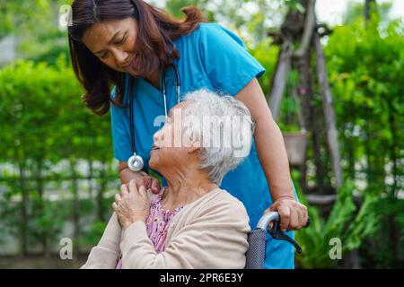 Asiatische ältere Frau Behinderung Patient sitzt auf Rollstuhl im Park, medizinisches Konzept. Stockfoto