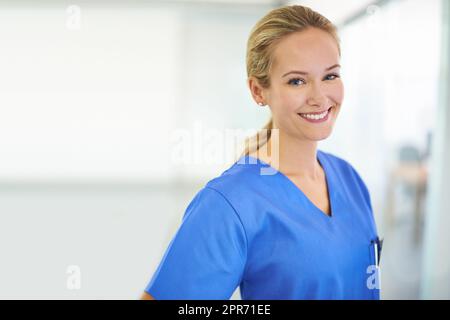 Medizin ist ihre Berufung. Porträt eines selbstbewussten jungen Arztes mit blauen Peelings. Stockfoto