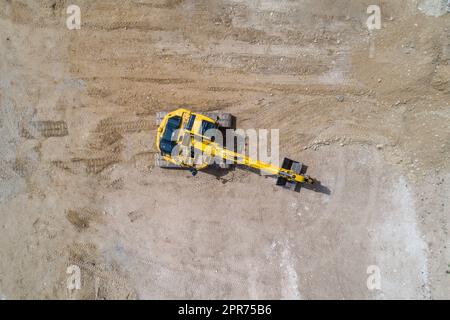 Bagger, der an einem Ort arbeitet, der den Boden gräbt Stockfoto