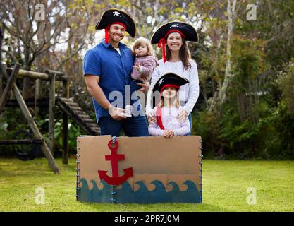 In meiner Familie ist verrückt relativ. Alle von ihnen. Eine Familie, die sich wie Piraten draußen im Hof verkleidet. Stockfoto