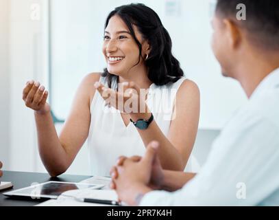 Ich habe eine Idee, die funktionieren könnte: Eine junge Geschäftsfrau, die sich mit ihren Kollegen in einem Büro trifft. Stockfoto