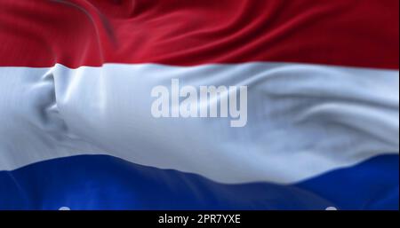 Nahaufnahme der niederländischen Nationalflagge, die im Wind weht. Die Niederlande sind ein Land im Nordwesten Europas. Textilhintergrund. Selektiver Fokus Stockfoto