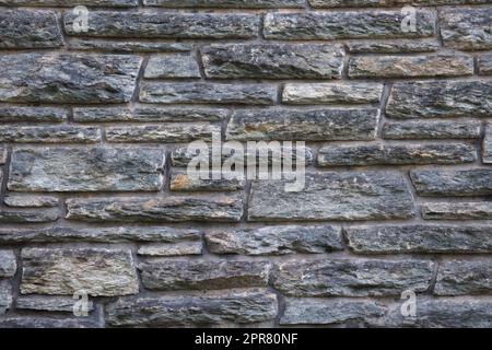 Graue Ziegelmauern alte Feldsteine Textur Hintergrund raue Steinbausteine Stockfoto