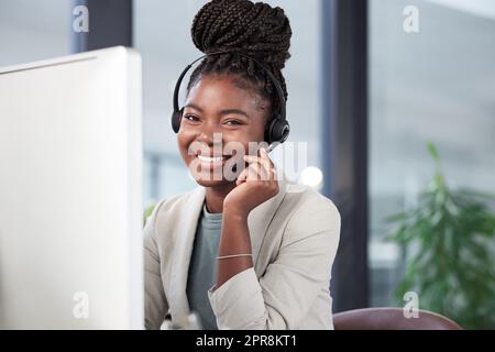 Lasst uns chatten und sehen, wie ich helfen kann. Porträt eines jungen Callcenter-Agenten, der an einem Computer in einem Büro arbeitet. Stockfoto