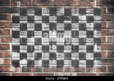 Motorsport karierte Flagge auf Backsteinmauer Hintergrund Stockfoto