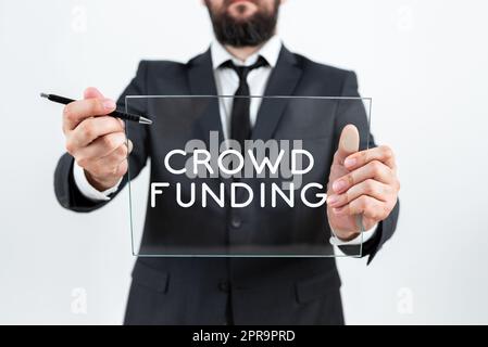 Text mit „Inspiration Crowd Funding“. Konzept bedeutet Fundraising Kickstarter Startup Pledge Plattform Spenden Geschäftsmann hält Stift und Glas und wirbt gleichzeitig für die Unternehmensmarke. Stockfoto