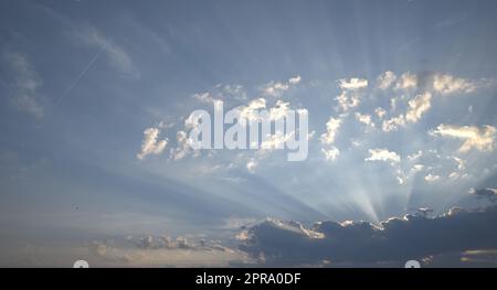 Sie leuchten durch die Wolken der Abend- oder Morgensonne Stockfoto