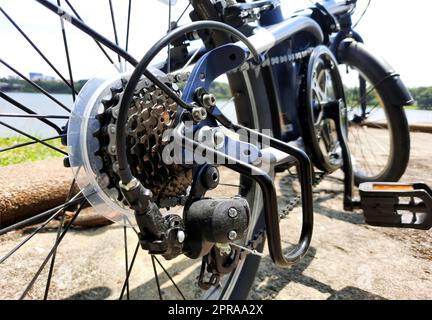 Fahrrad Zahnräder in Nahaufnahme mit mechanischen Zahnradkassette und Kette am Hinterrad des Faltrades Stockfoto