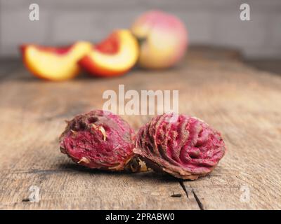 Nahaufnahme von Pfirsichgruben auf einem rustikalen Gartentisch Stockfoto