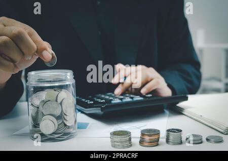 Hand hält Geld Münze sparen Investitionen in jar.Business Finance Buchhaltung Wirtschaft Konzept. Stockfoto