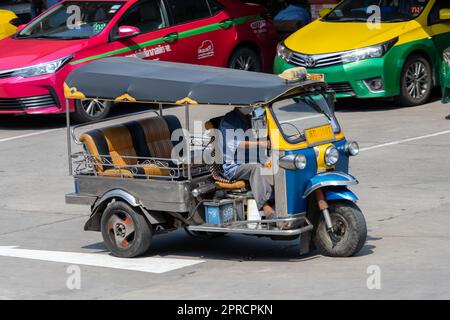 SAMUT PRAKAN, THAILAND, FEBRUAR 07 2023, Ein traditionelles Motordreirad - Tuk Tuk fährt auf einer Straße Stockfoto