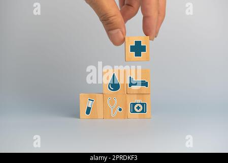 Hand hält Holzwürfel Block mit Versicherung Krankenwagen medizinischen Symbol auf dem Hintergrund und Platz kopieren. Stockfoto