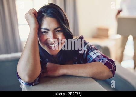 Und so beginnt das neue Abenteuer. Porträt einer jungen Frau beim Umzug. Stockfoto