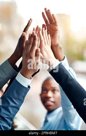 Auf großen Erfolg ausgerichtet. Nahaufnahme einer Gruppe von nicht erkennbaren Geschäftsleuten, die sich gegenseitig hoch verfünffach haben. Stockfoto