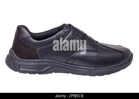 Schwarze Männerschuhe. Nahaufnahme eines einzelnen schwarzen Turnschuhs oder Sportschuhs, isoliert auf weißem Hintergrund. Beschneidungspfad. Elegante und trendige Herrenschuhe. Makro. Stockfoto