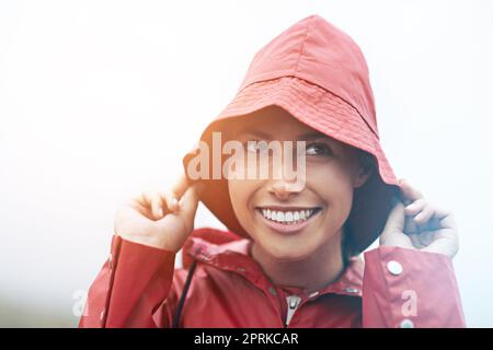 Die Vorhersage sagte Regen voraus. Eine junge Frau, die im Regen steht Stockfoto