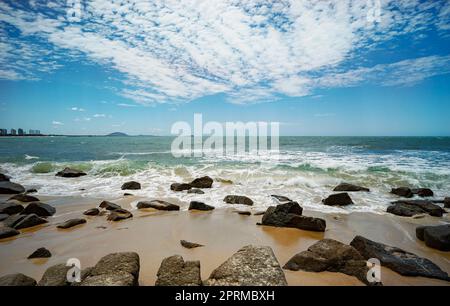 Blick nach Norden vom Alexandra Headland Beach, einem Küstenabschnitt von Maroochydore, Sunshine Coast, Queensland, Australien. Felsiger Vorstrand mit brechenden Wellen Stockfoto