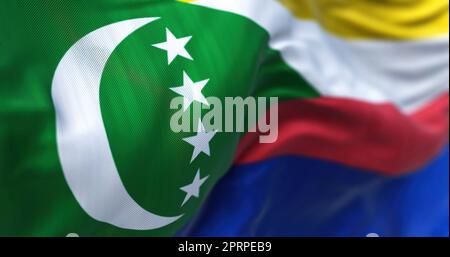 Nahaufnahme der im Wind winkenden komoroischen Nationalflagge. Die Union der Komoren ist ein Inselstaat im Indischen Ozean. Stoffstruktur Stockfoto