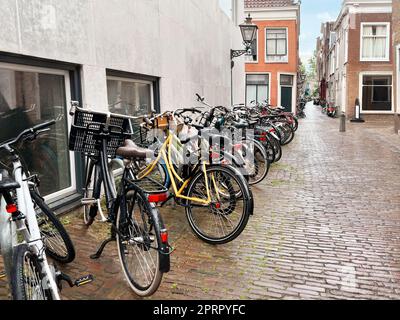 Viele geparkte Fahrräder in der Nähe des Gebäudes an der Stadtstraße Stockfoto