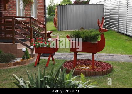 Hirschförmige Töpfe mit Pflanzen im Garten Stockfoto