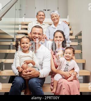 Große Familie, drei Generationen und das Glück von Kindern, Eltern und Großeltern, die zusammen auf der Treppe in ihrem Zuhause sitzen und lächeln. Bindung, Unterstützung und Nähe von Kindern zu Mann und Frau Stockfoto