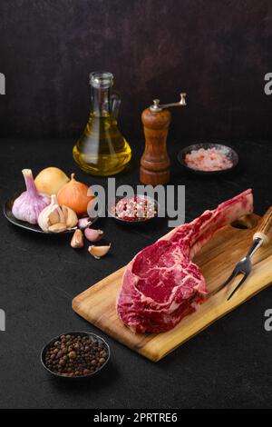 Raw beef cowboy steak with spice ready for cooking Stock Photo