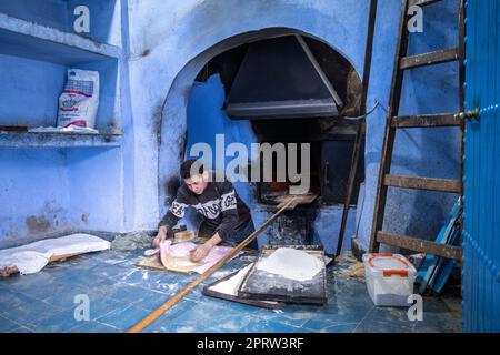 Bäckerei backt Brot in einem traditionellen Holzofen in der Medina von Chefchaouen. Stockfoto