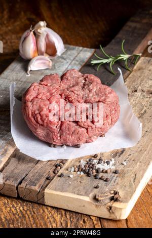 Rohes Hackfleisch auf dunklem Holz Stockfoto