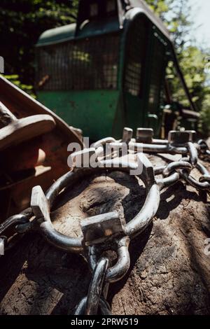 Traktionsketten auf dem großen Rad eines Holzstaplers Stockfoto