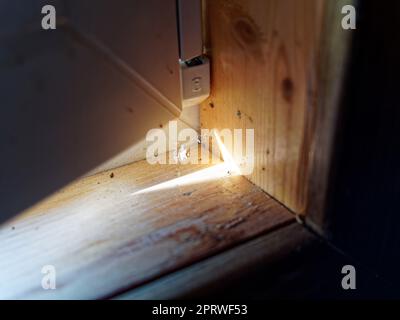 Spinnweben in der Ecke des Fensters, helle Sonne Stockfoto