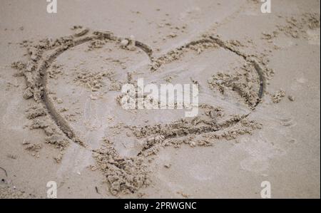 Liebe Zeichen auf Sand. Love Heart Symbol im Sand am tropischen Strand. Feiertage Hintergründe Texturen. Puri, Odisha, Indien Stockfoto