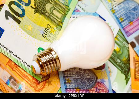 Wirtschaftliche LED-Glühlampe auf Euro-Banknoten Stockfoto