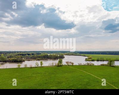 Luftaufnahme über den Zusammenfluss des alten Kanals und der Moskva im Bezirk Krasnogorsk der Moskauer Region. Fußweg auf grüner Wiese Stockfoto